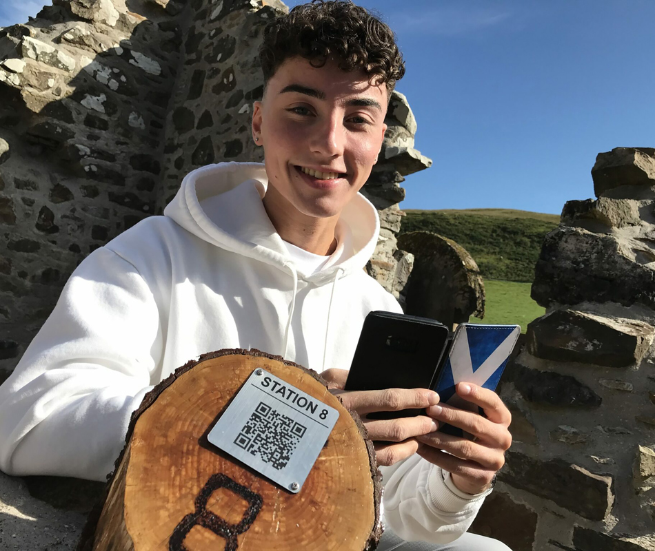 Sam Mcmanus Shanks At Historic Kilbride Listening To The Audio Tour He Wrote, Credit Kathie Griffiths Oban Timesjpg.